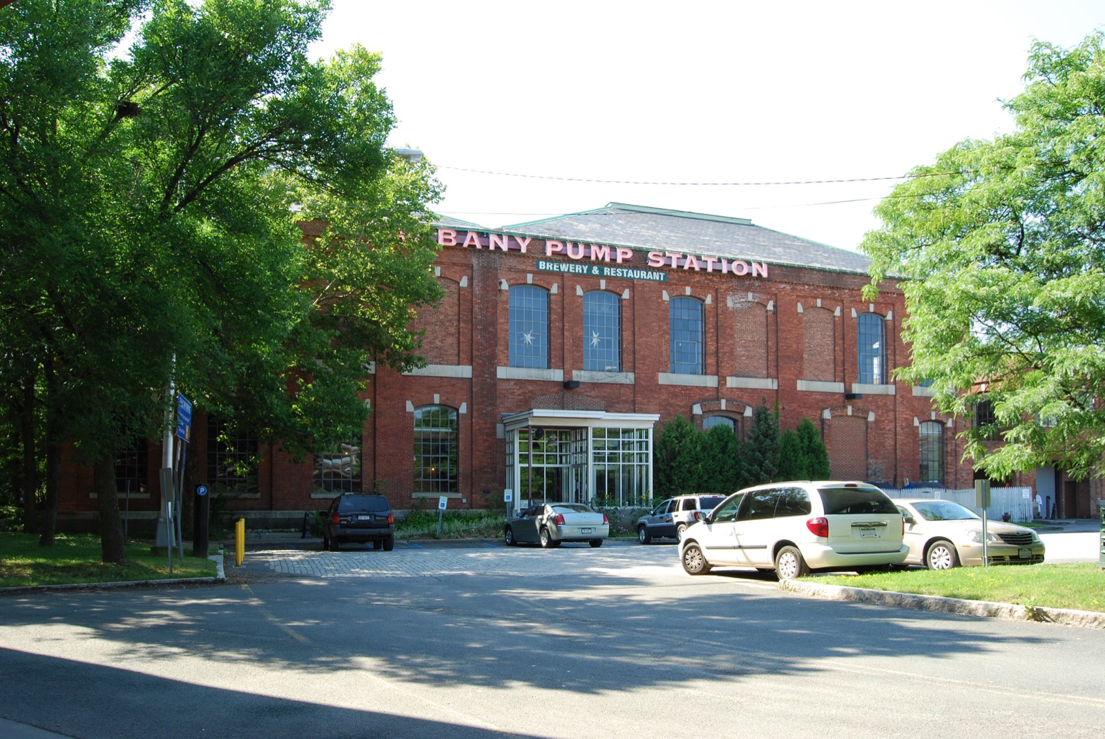 Brick industrial building with arched windows housing the Albany Pump Station brewery and restaurant