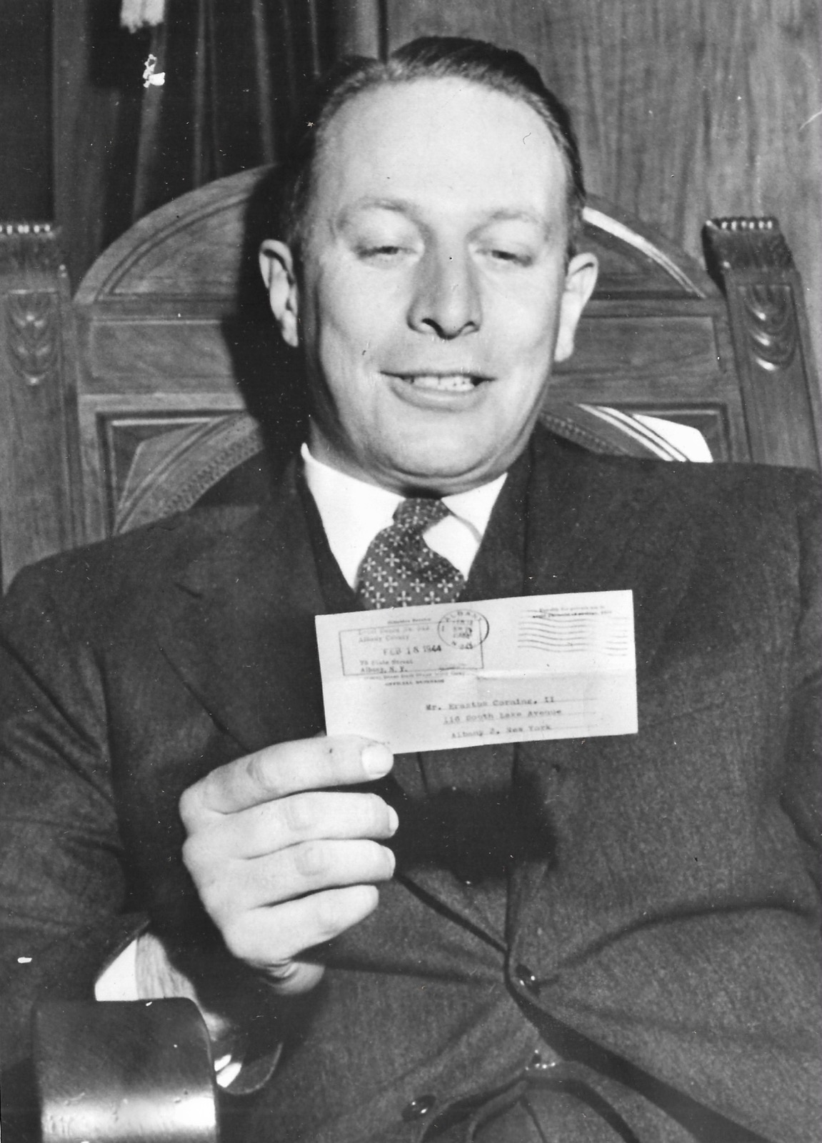 Black-and-white press photo of Mayor Erastus Corning 2nd holding his draft notice